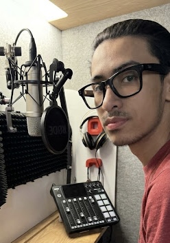 Ben Pacheco in his home recording studio with microphone and RØDECaster